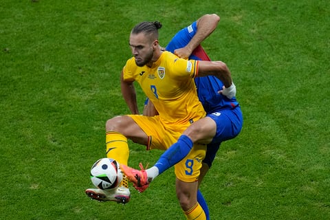 George Puscas and David Hancko battle for the ball 